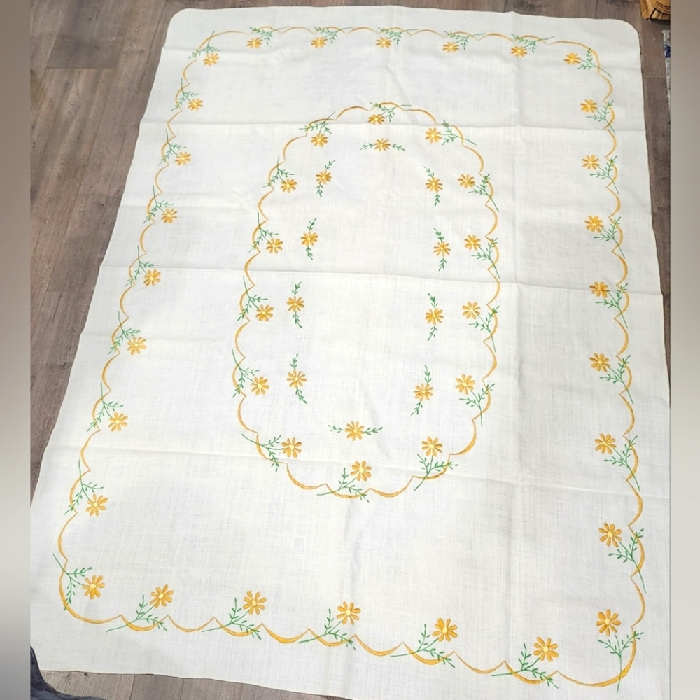 Vintage ring of yellow flowers on an off white tablecloth 48x66